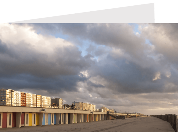 colorful beach hunts with the seafront buildings in the background